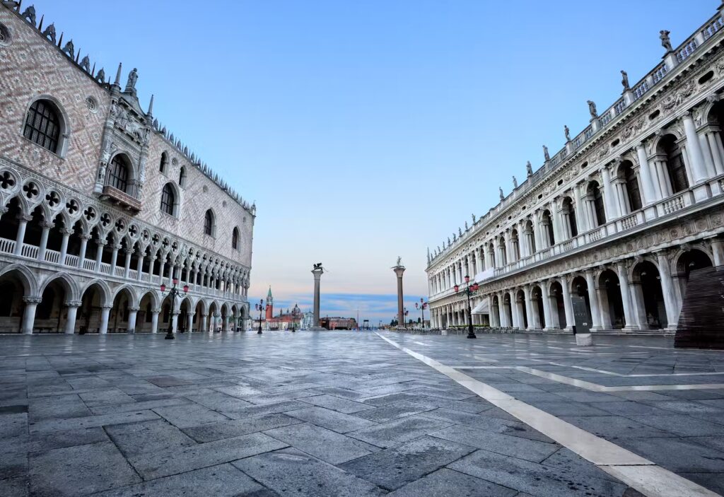 Venice's Piazza San Marco at dawn, showcasing the Doge's Palace and Procuratie Vecchie architecture.