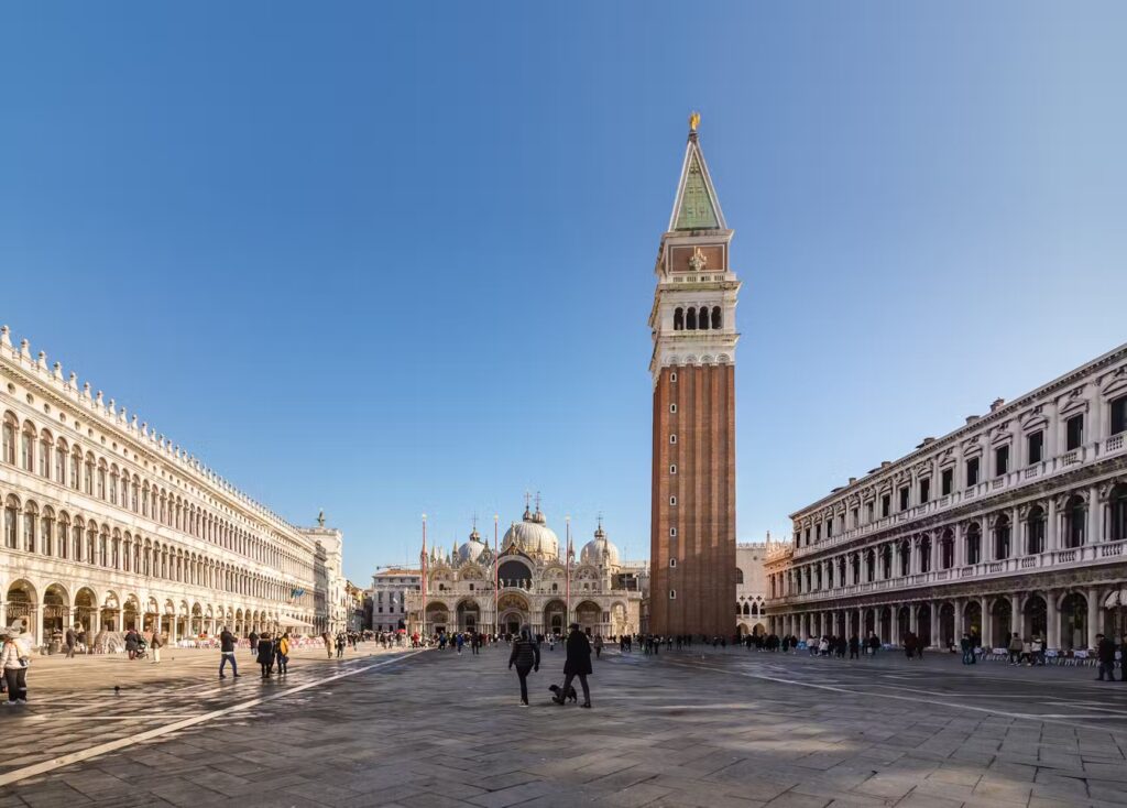 St. Mark's Square, Venice, featuring the Campanile and Basilica under a clear blue sky.